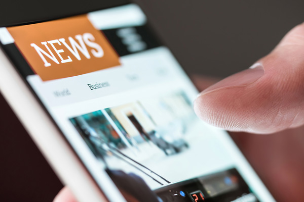 © Adobe Images: Mobile news application in smartphone